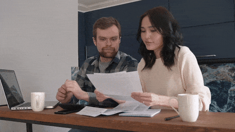 A couple goes through their application documents for the flat search